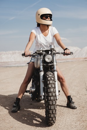 Woman Riding a Motorcycle on sand