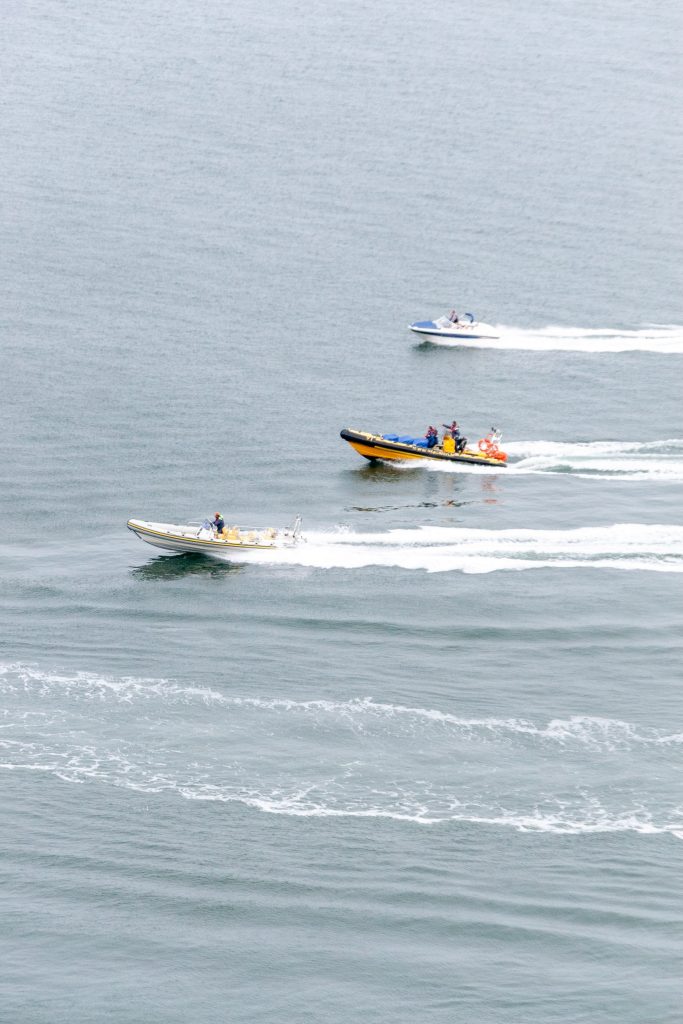 Three Marine Boats racing out on the waters