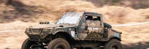 dirty 4x4 vehicle starting in a off road competition. dynamic shot of car on in the off road circuit race
